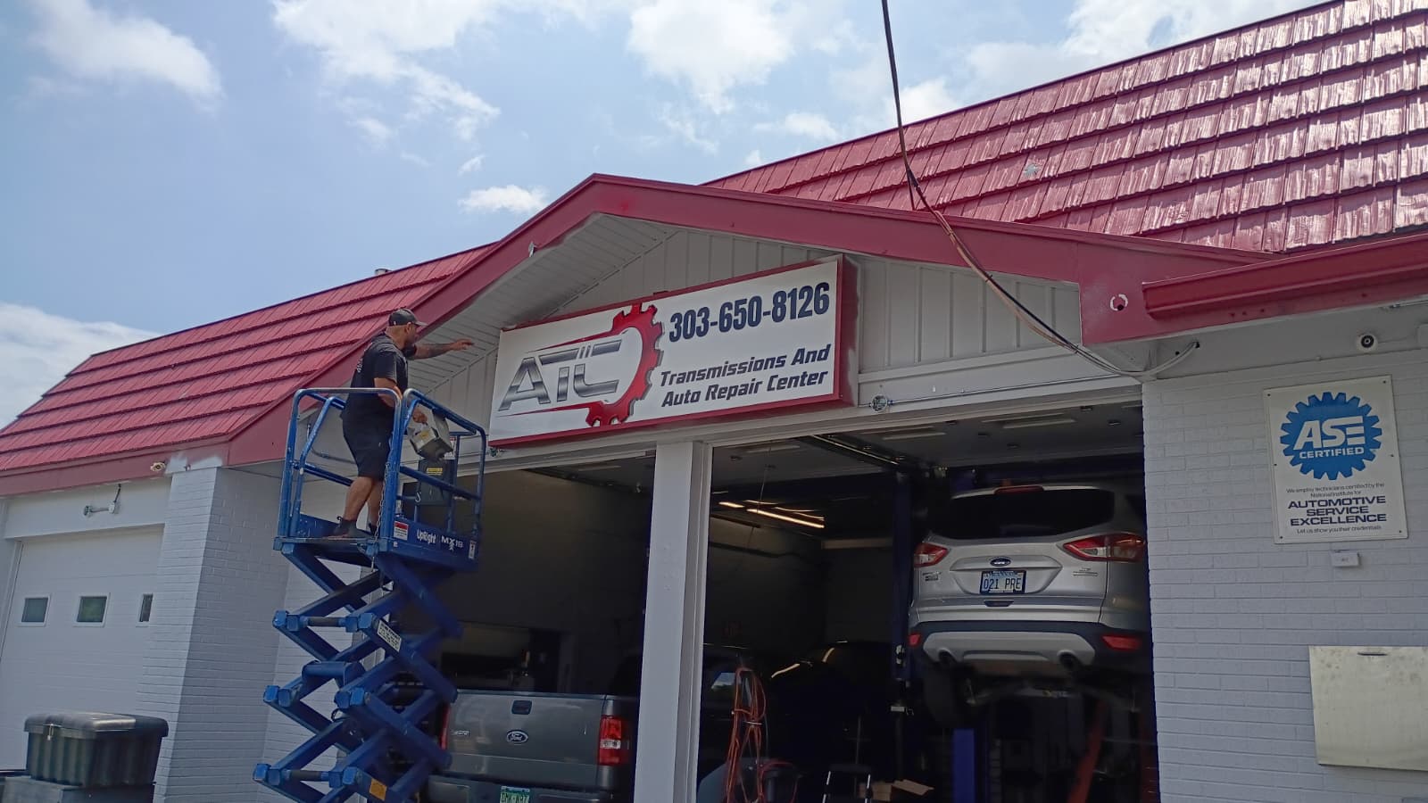 ikonic team installing a storefront sign